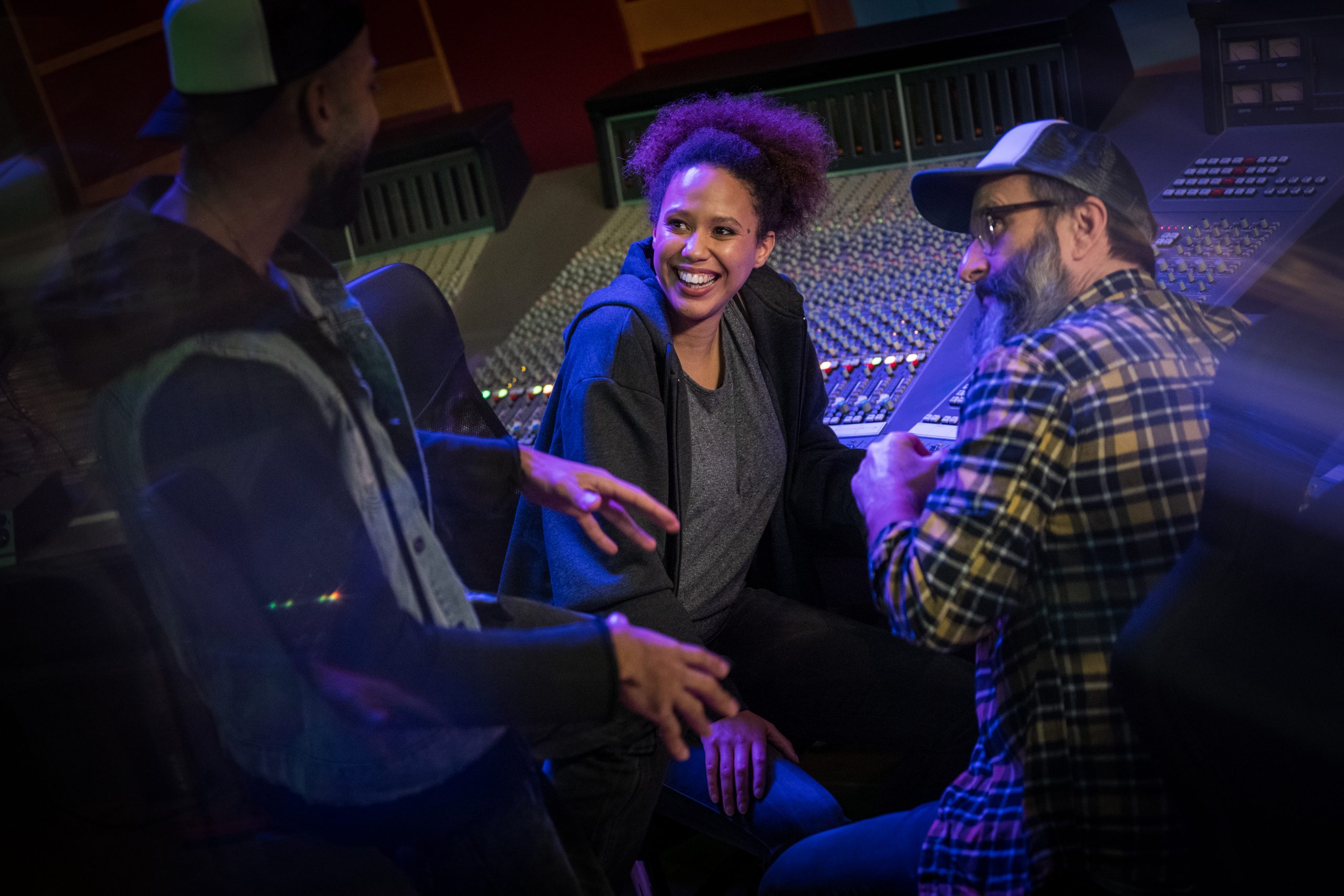 Male singer talking with female singer and composer in studio